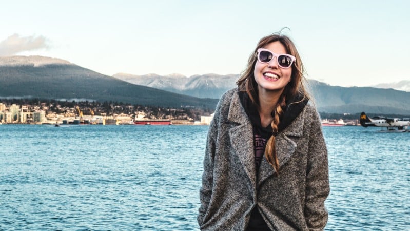 woman sightseeing in front of a lake